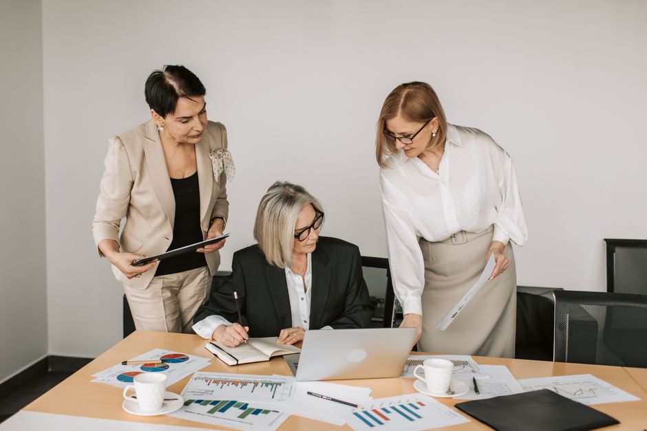 Team reviewing curated corporate gift set selections in a modern office setting